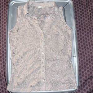 A medium size tan sleeveless blouse